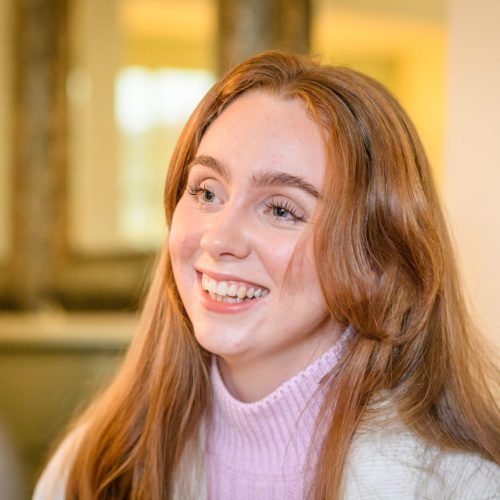 an-attractive-red-haired-young-woman-smiling-weari-2024-12-01-23-57-54-utc